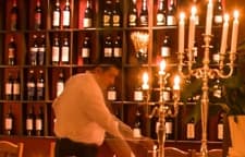 Service by the wine shelves in candlelight